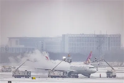 Aircraft deicing operation at Beijing Daxing International Airport in winter snow