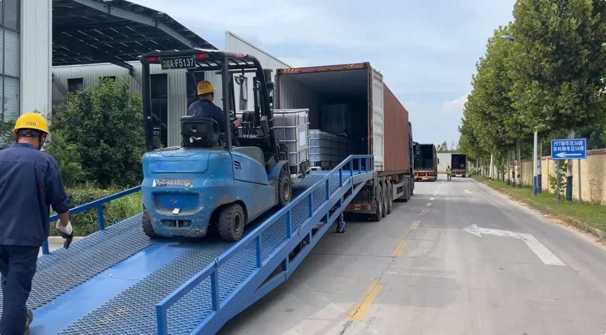 Forklift loading DOTP IBC totes onto truck at warehouse, 6x40GP shipment to India