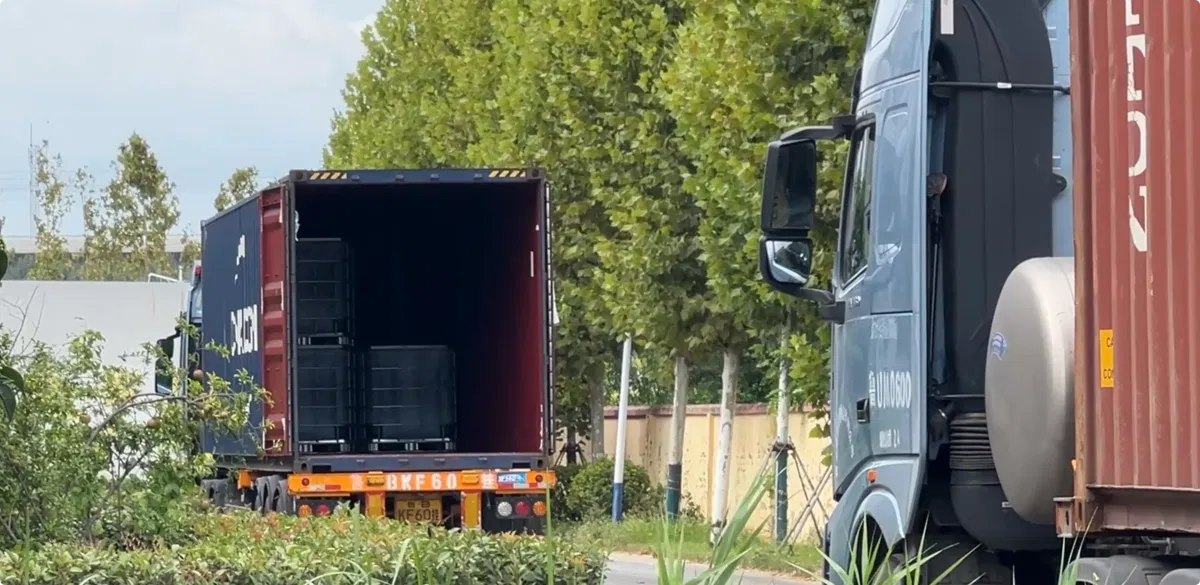 Trucks queuing at the warehouse loading bay, with DOTP IBC totes still being loaded into the container box