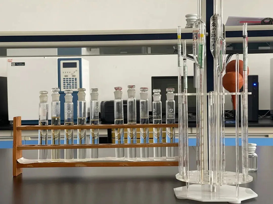 Glass test tubes and volumetric flasks arranged on wooden and acrylic racks