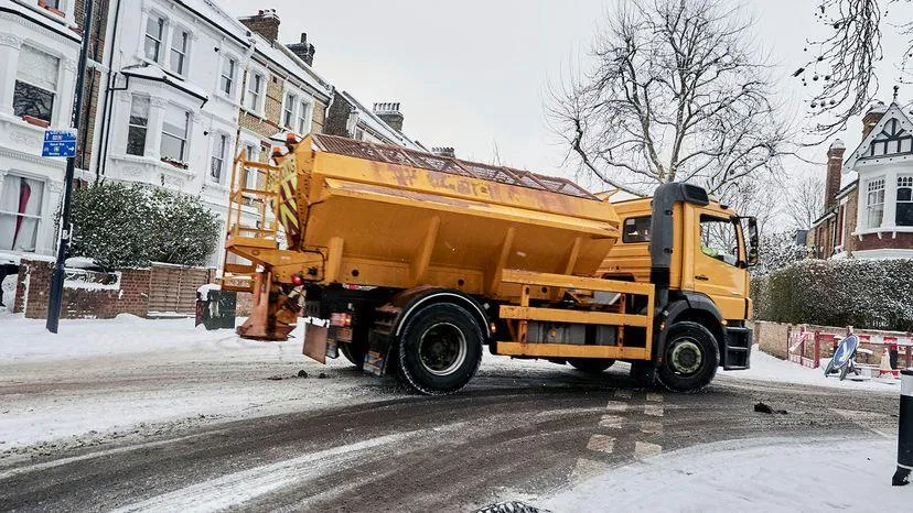 Road salt truck deicing highway in winter 鈥?MEG-based liquid deicer alternative to rock salt