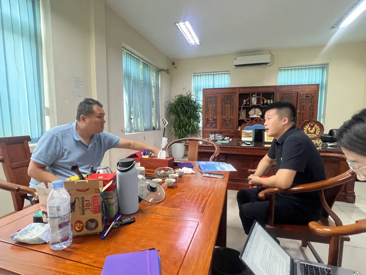 Chinese entrepreneur discussing MEG supply at his Vietnam factory