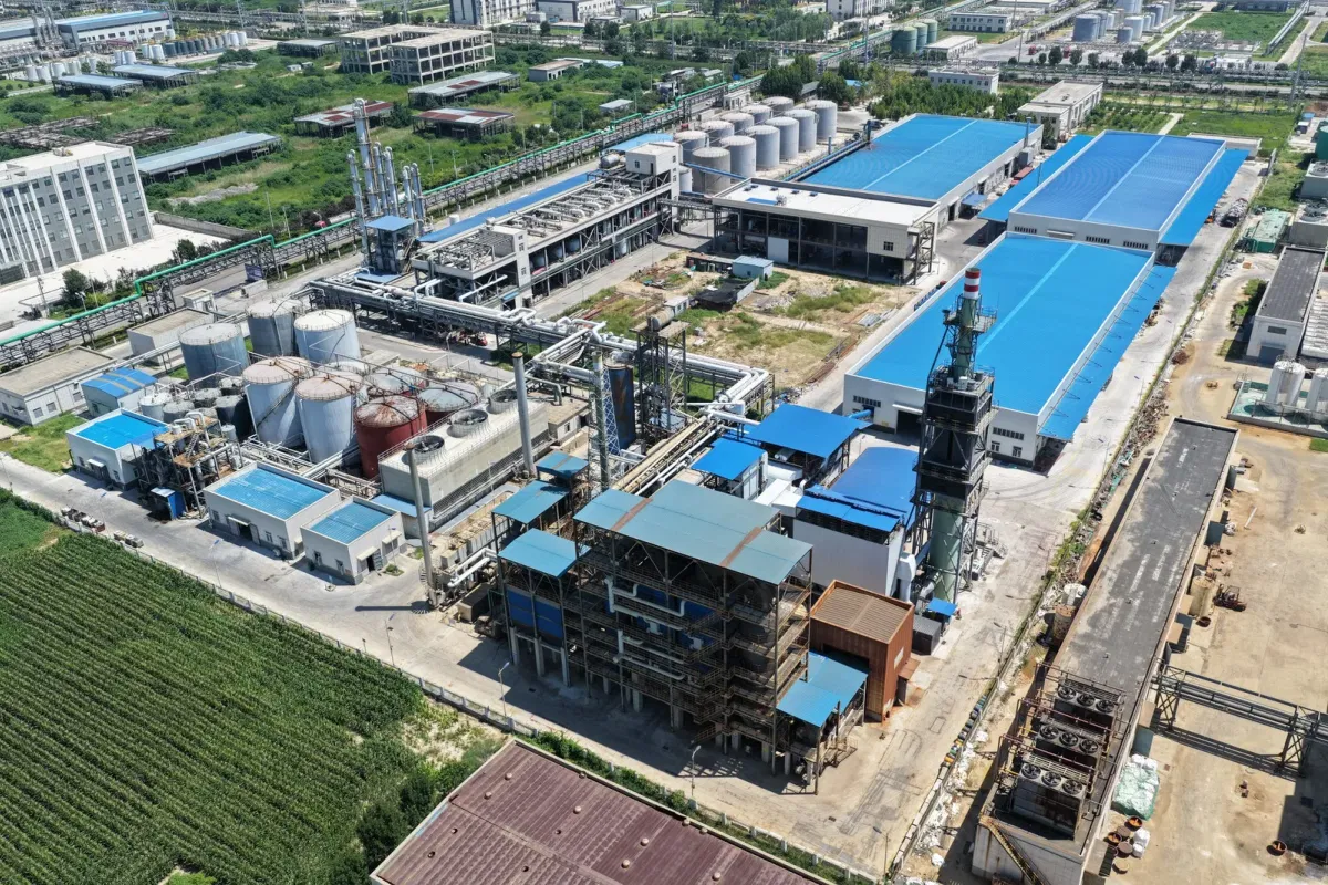 Biomass gasifier unit at Wansheng plasticizer factory using recycled grain-straw pellets to heat thermal oil