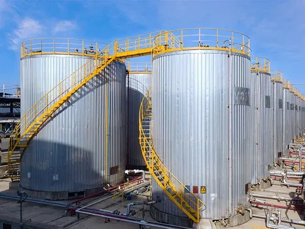 Outdoor storage tanks with safety railings at warehouse facility